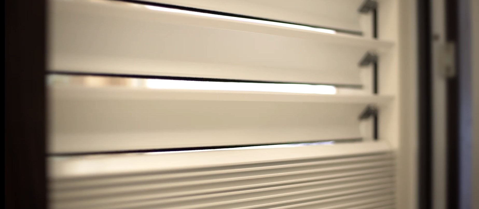 light colored blinds using motorization to roll up a window